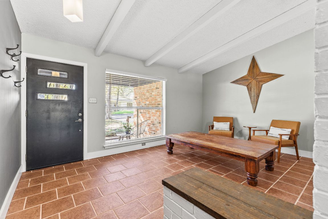 1906 Parkside Lane Austin, TX 78745 - Photo 12 of 40 Tiled foyer entrance with a textured ceiling and baseboards