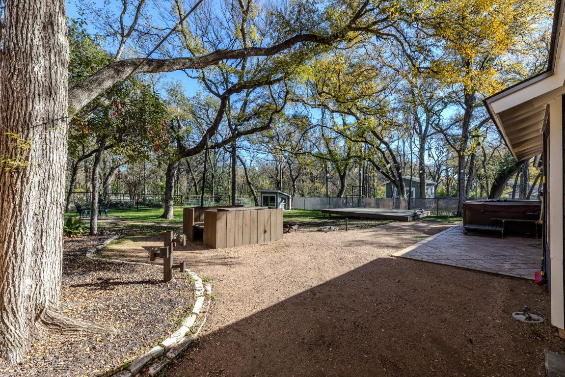 1906 Parkside Lane Austin, TX 78745 - Photo 33 of 40 View of yard featuring a hot tub, a patio area, and an outbuilding