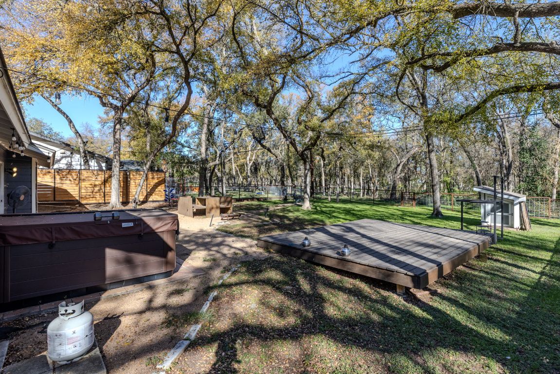 1906 Parkside Lane Austin, TX 78745 - Photo 34 of 40 Fenced backyard with a wooden deck and a hot tub