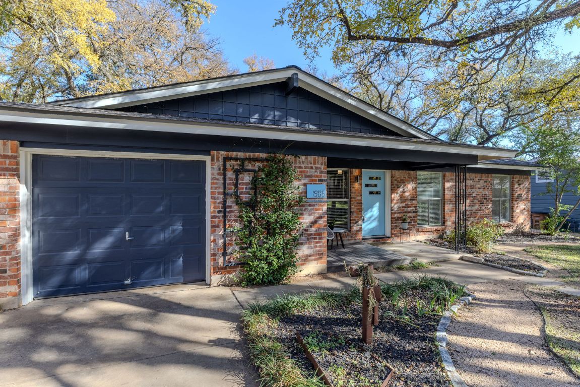 1906 Parkside Lane Austin, TX 78745 - Photo 37 of 40 View of front of home featuring brick siding, concrete driveway, and an attached garage