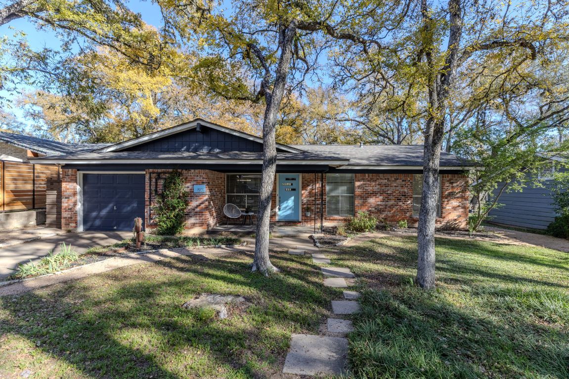 1906 Parkside Lane Austin, TX 78745 - Photo 38 of 40 View of front of house featuring a front lawn, a garage, brick siding, and covered porch