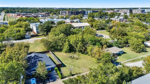 an aerial view of multiple houses with yard