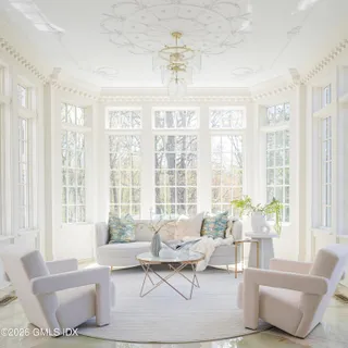 a dining room with furniture a fireplace and wooden floor