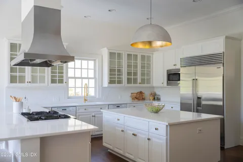 a kitchen with a sink appliances and cabinets