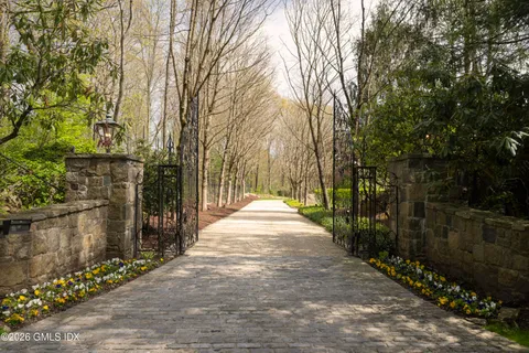 a view of a pathway with a wrought fence