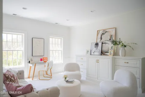 a bedroom with a bed a desk and chair