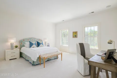 a bedroom with a bed and lamp