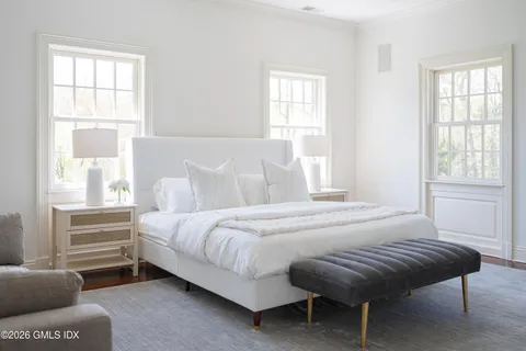 a bedroom with bed and window
