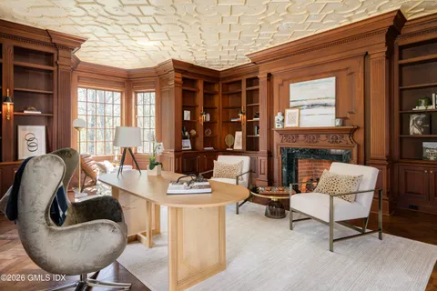 a living room with a fireplace and a rug