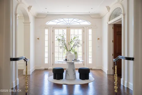 a living room with furniture a fireplace and a chandelier