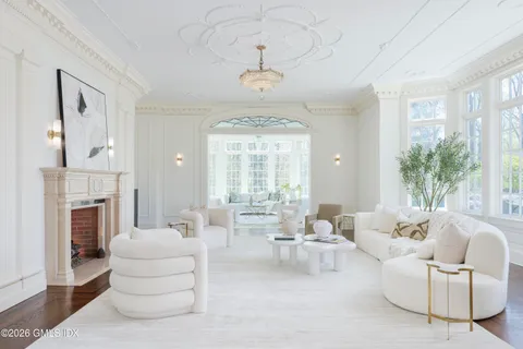 a living room with furniture and floor to ceiling windows