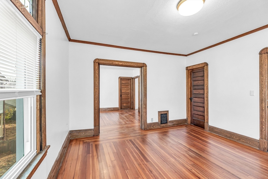 21 Biltmore Street, Unit 1 Springfield, MA 01108 - Photo 4 of 17 a view of empty room with wooden floor and fan