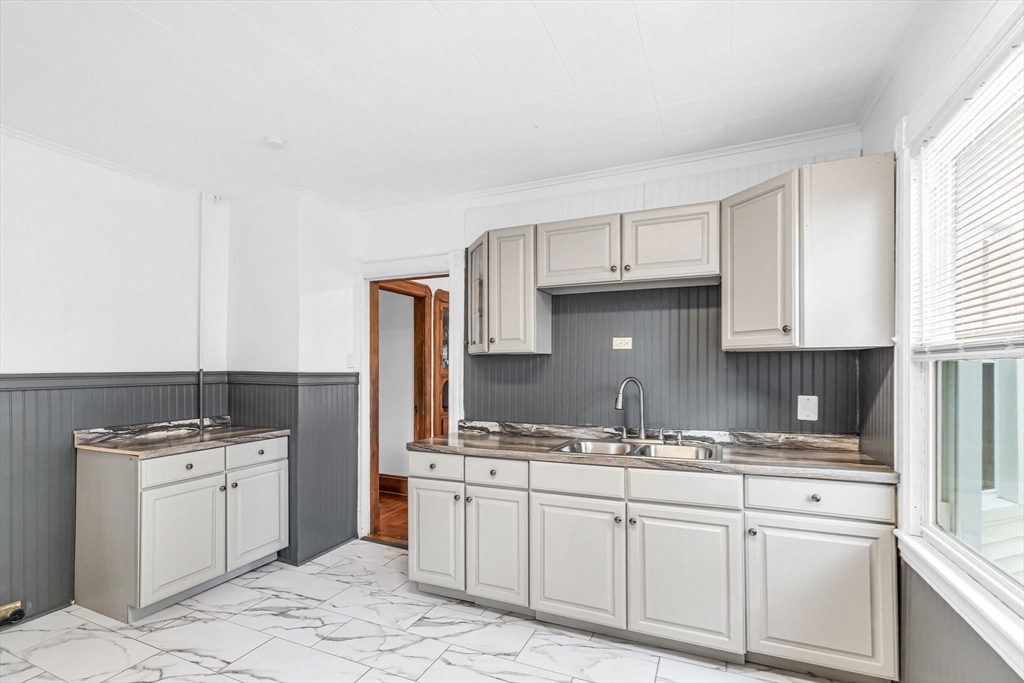 21 Biltmore Street, Unit 1 Springfield, MA 01108 - Photo 7 of 17 a kitchen with granite countertop a sink stove and cabinets