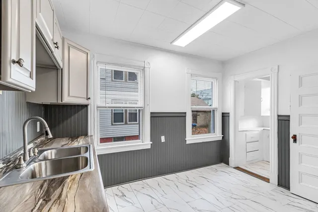 a bedroom with a bed next to a window