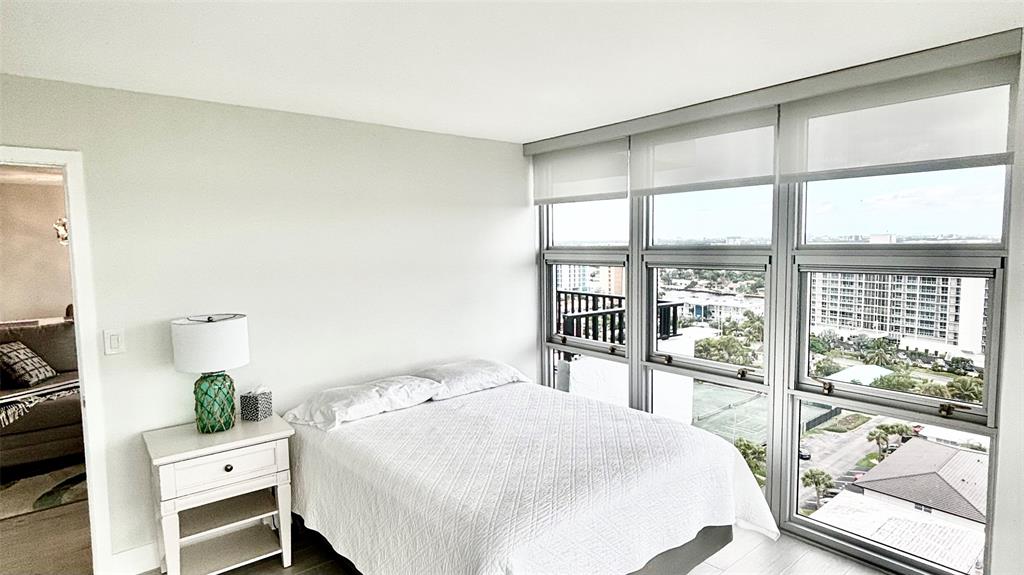 531 North Ocean Boulevard, Unit 1601 Pompano Beach, FL 33062 - Photo 13 of 32 a bedroom with a bed and a large window