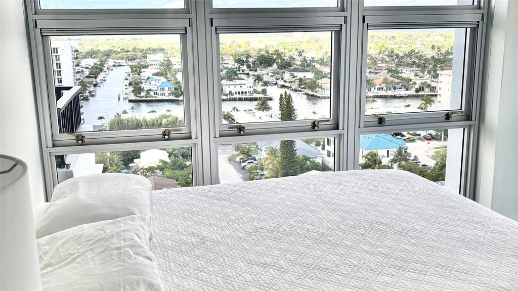 531 North Ocean Boulevard, Unit 1601 Pompano Beach, FL 33062 - Photo 14 of 32 a bedroom with a bed and a large window with outer view