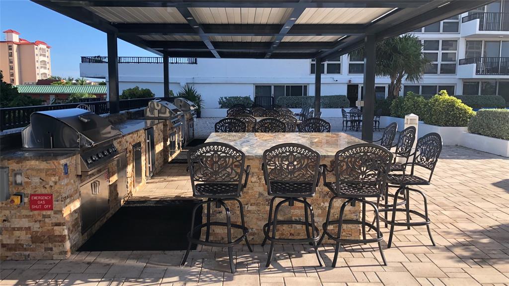 531 North Ocean Boulevard, Unit 1601 Pompano Beach, FL 33062 - Photo 20 of 32 a view of a patio with table and chairs