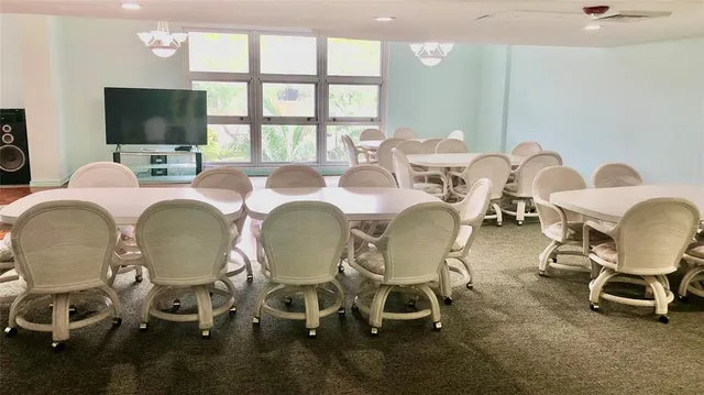 a group of dining room with furniture