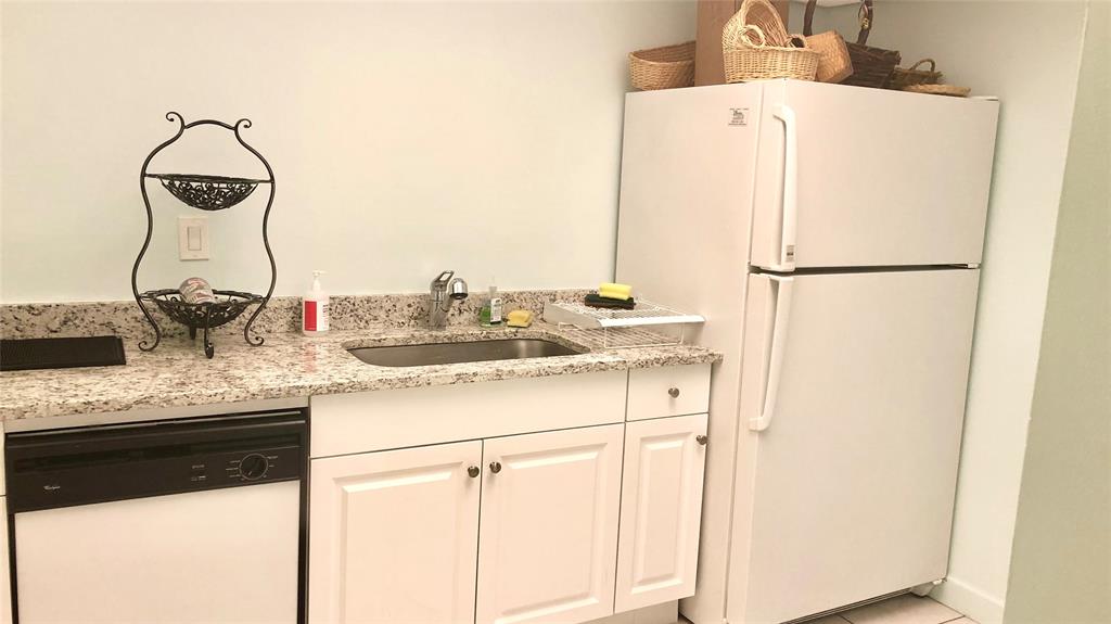 531 North Ocean Boulevard, Unit 1601 Pompano Beach, FL 33062 - Photo 30 of 32 a kitchen with a sink and a refrigerator