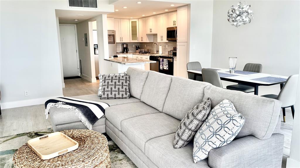 531 North Ocean Boulevard, Unit 1601 Pompano Beach, FL 33062 - Photo 3 of 32 a living room with furniture and a fireplace