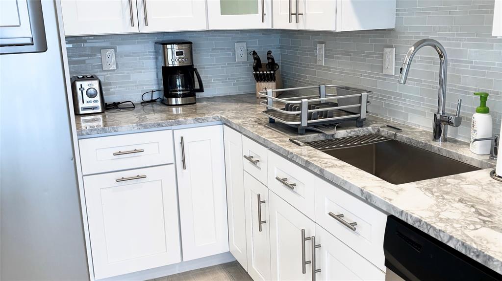 531 North Ocean Boulevard, Unit 1601 Pompano Beach, FL 33062 - Photo 6 of 32 a kitchen with granite countertop a sink and a stove top oven