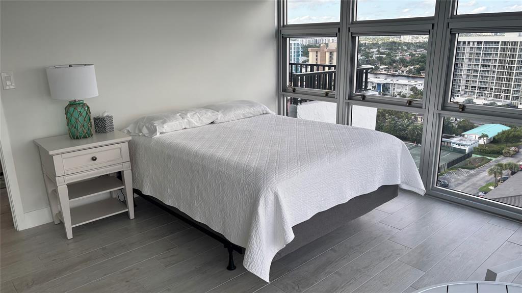 531 North Ocean Boulevard, Unit 1601 Pompano Beach, FL 33062 - Photo 9 of 32 a bedroom with a bed and a large window