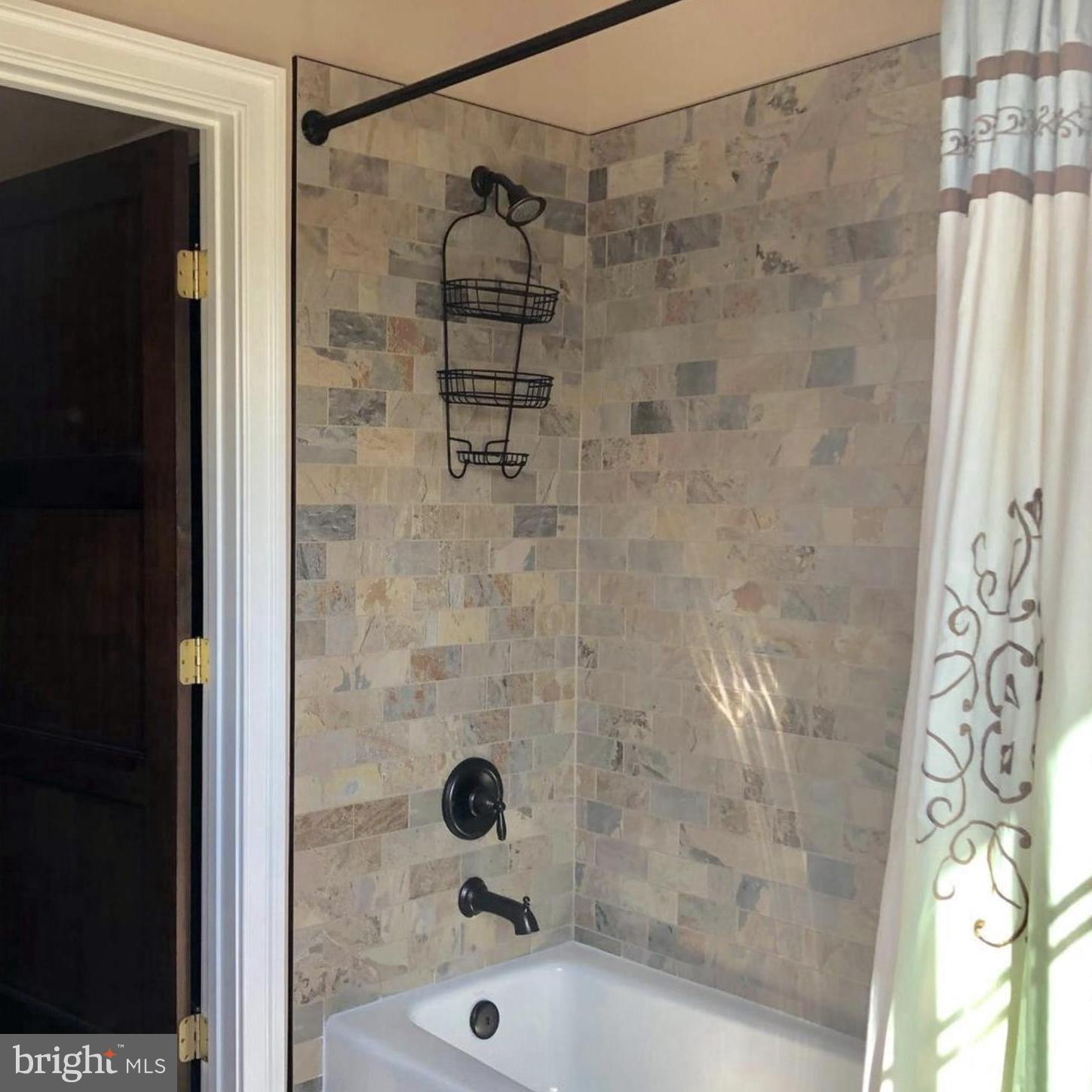 37793 Baker Mill Road, Unit 1 Purcellville, VA 20132 - Photo 12 of 14 a bathroom with a shower and a sink