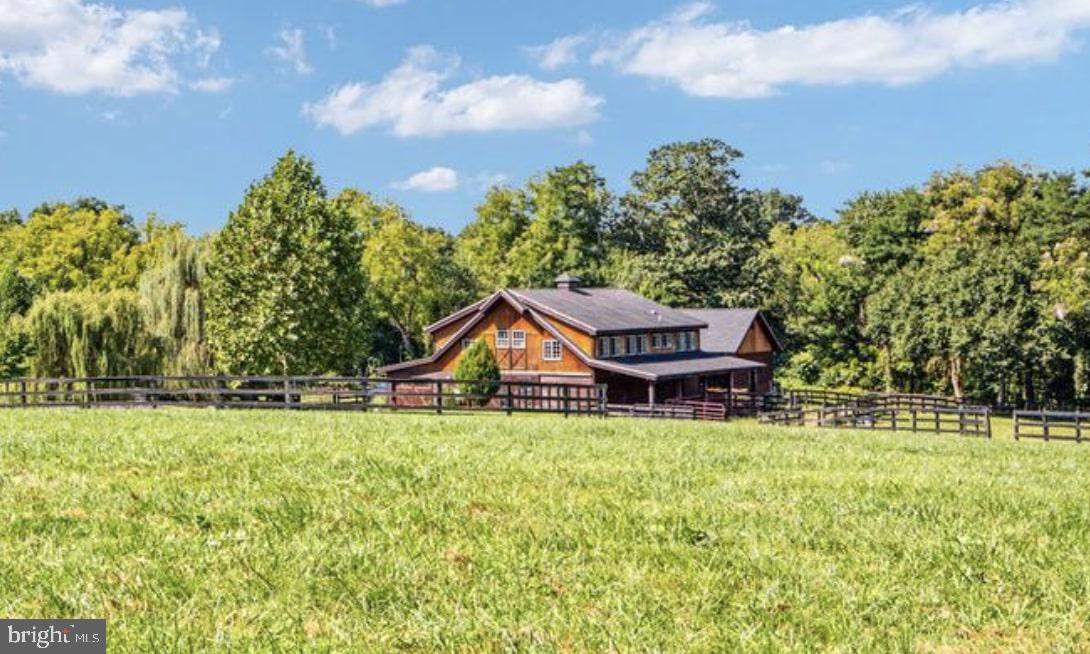 37793 Baker Mill Road, Unit 1 Purcellville, VA 20132 - Photo 2 of 14 a house with trees in the background