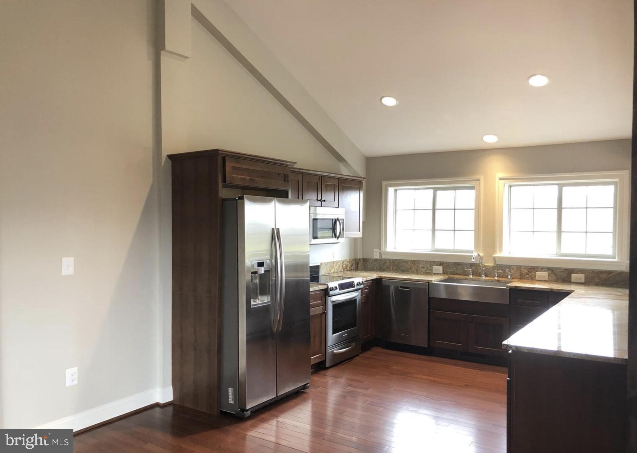 37793 Baker Mill Road, Unit 1 Purcellville, VA 20132 - Photo 7 of 14 a kitchen with stainless steel appliances granite countertop a sink a stove and refrigerator