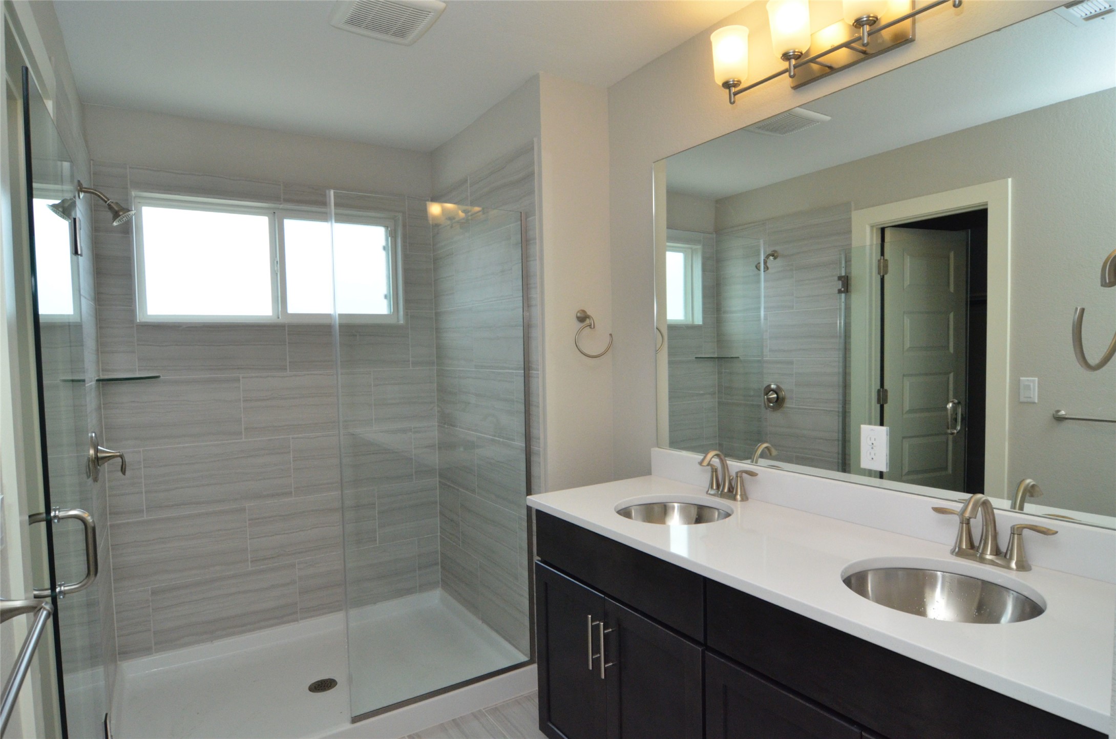 1916 Cleese Drive Austin, TX 78741 - Photo 23 of 36 Double vanity and a spacious glass-enclosed shower create a modern, efficient bathroom retreat.