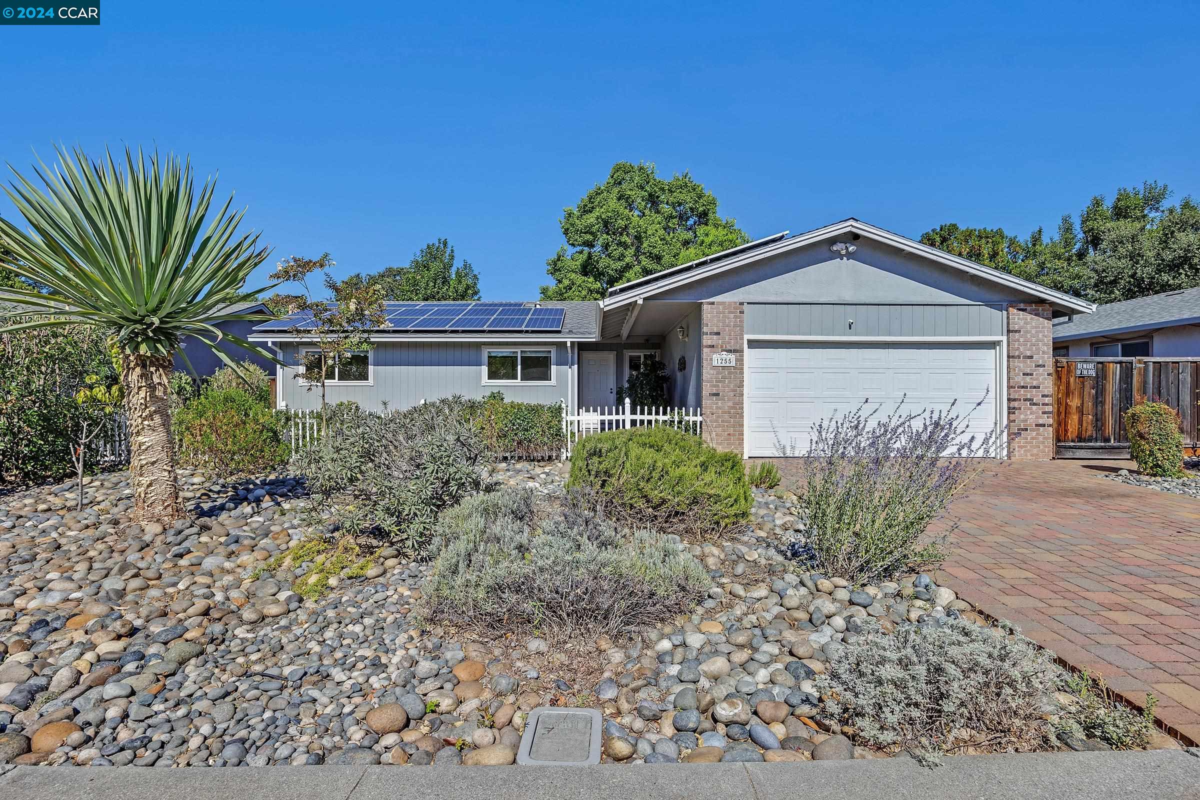 a front view of a house with a garden