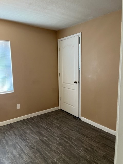 1614 Ryon Street, Unit A Houston, TX 77009 - Photo 5 of 12 a view of an empty room with wooden floor and a window