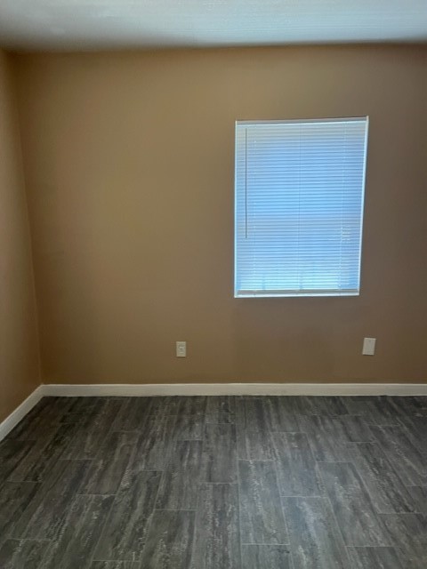 1614 Ryon Street, Unit A Houston, TX 77009 - Photo 7 of 12 an empty room with wooden floor and windows