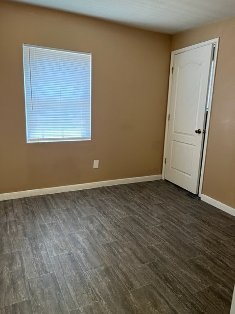 1614 Ryon Street, Unit A Houston, TX 77009 - Photo 9 of 12 an empty room with wooden floor and windows