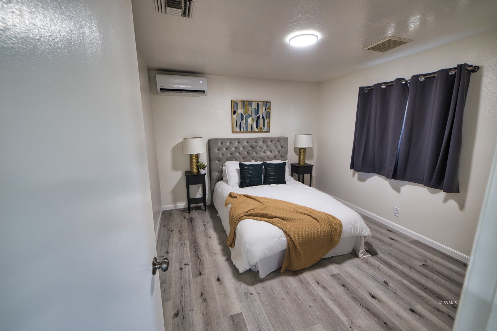 1101 South Farragut Street Ridgecrest, CA 93555 - Photo 13 of 18 a bedroom with a bed and a chandelier