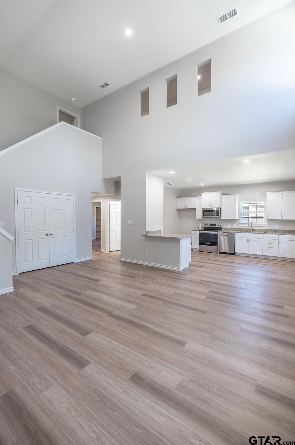 233 Harrison Street Longview, TX 75601 - Photo 12 of 44 a view of a kitchen with furniture and wooden floor