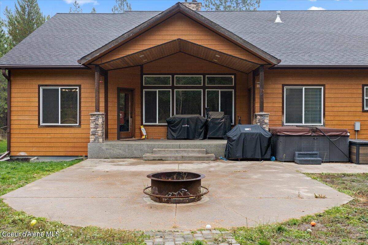 24665 Hunters Grove Court Rathdrum, ID 83858 - Photo 44 of 57 Back with Hottub and Fire Pit