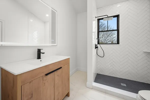 a kitchen with a sink a mirror and a shower