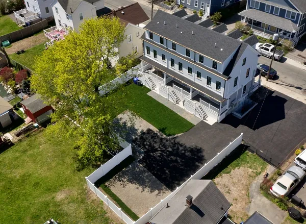 an aerial view of a residential apartment building with a yard