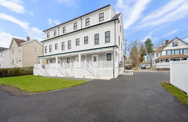 a view of building with yard in front of it