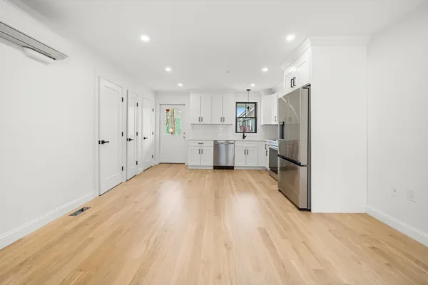 a kitchen with stainless steel appliances a refrigerator sink and cabinets