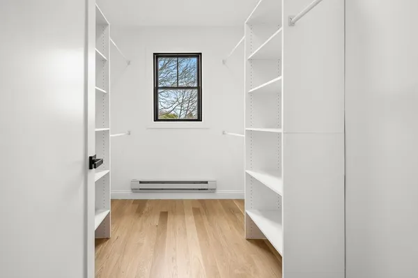 a view of walk in closet with empty racks