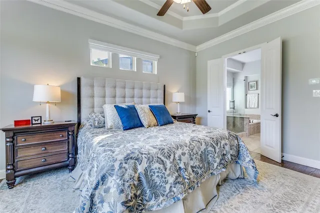 a bedroom with a bed and a lamp on dresser