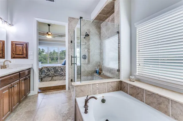 a bathroom with a tub sink and mirror
