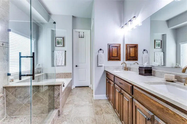 a large bathroom with a double vanity sink a mirror and a shower