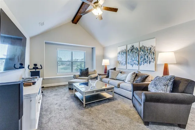 a living room with furniture a rug and a chandelier