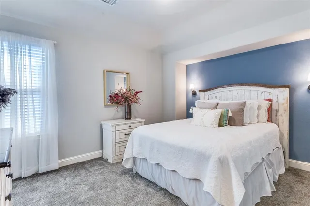 a bedroom with a large bed and a chandelier