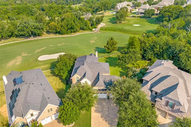 an aerial view of a house with a yard basket ball court and outdoor seating