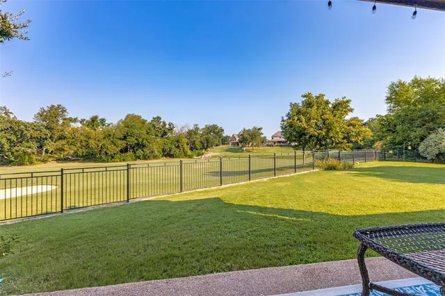 a view of a swimming pool with a yard