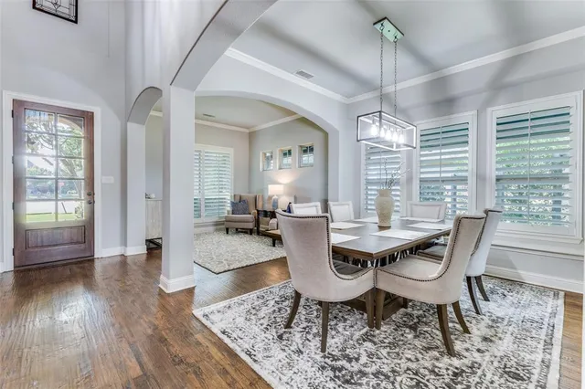 a view of a dining room with furniture wooden floor and chandelier